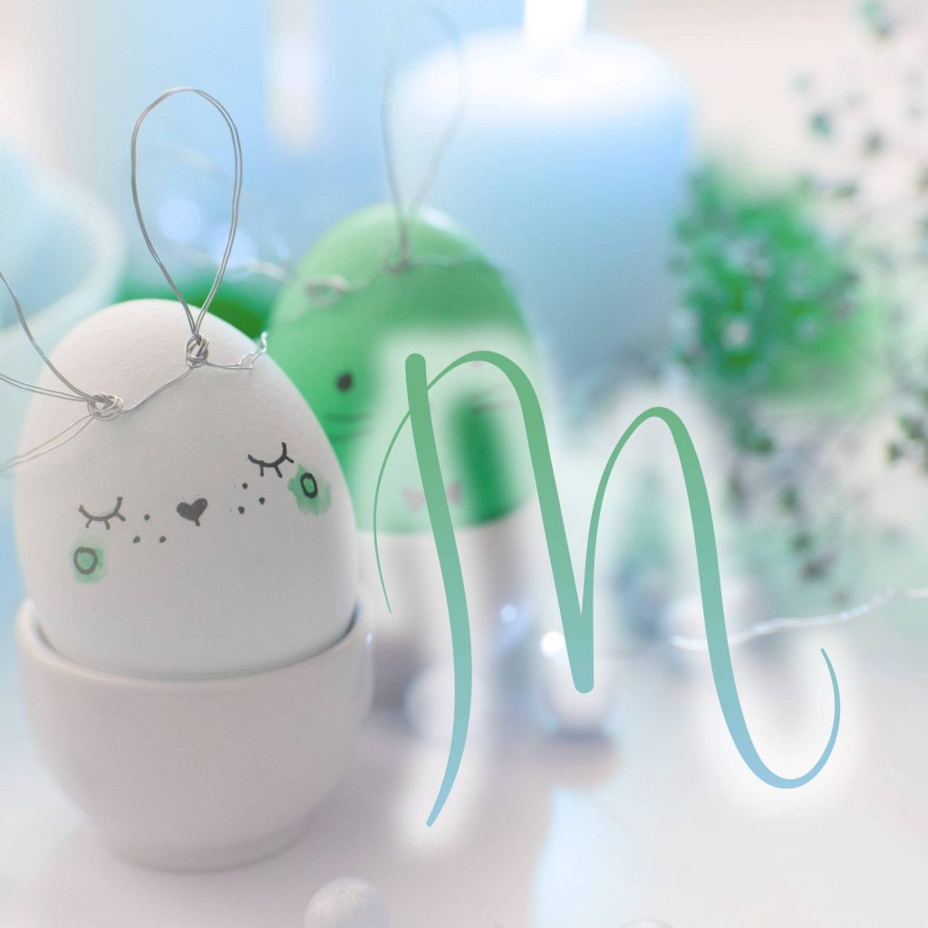 Cute hand-drawn Easter egg with wire bunny ears in ceramic cup with minimalist sage M background Wallpaper