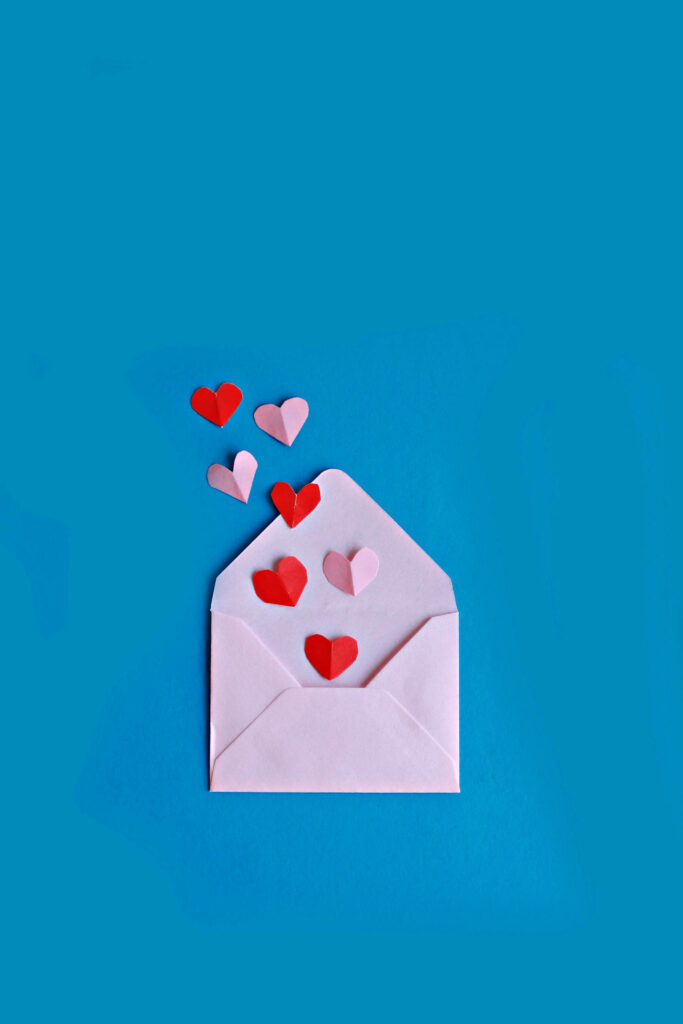Heartfelt iPhone Wallpaper: Pink Envelope & Hearts on Blue Background