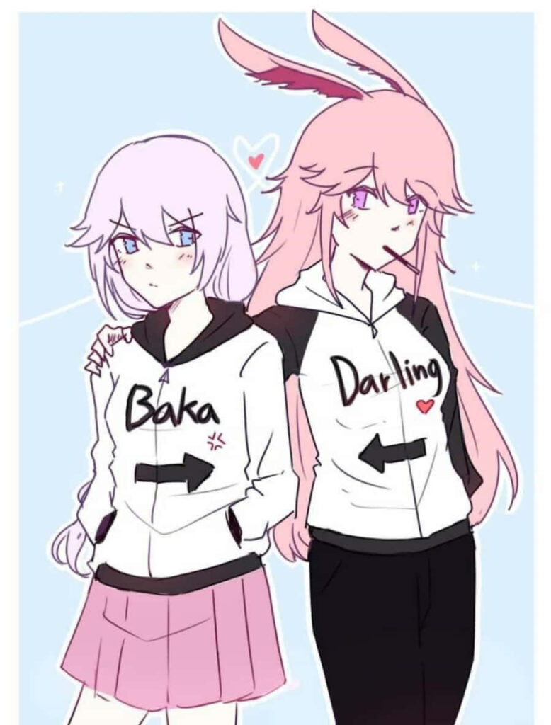 Love in Pastel: Adorable Anime Girls Embrace in Matching Pink Hoodies Wallpaper