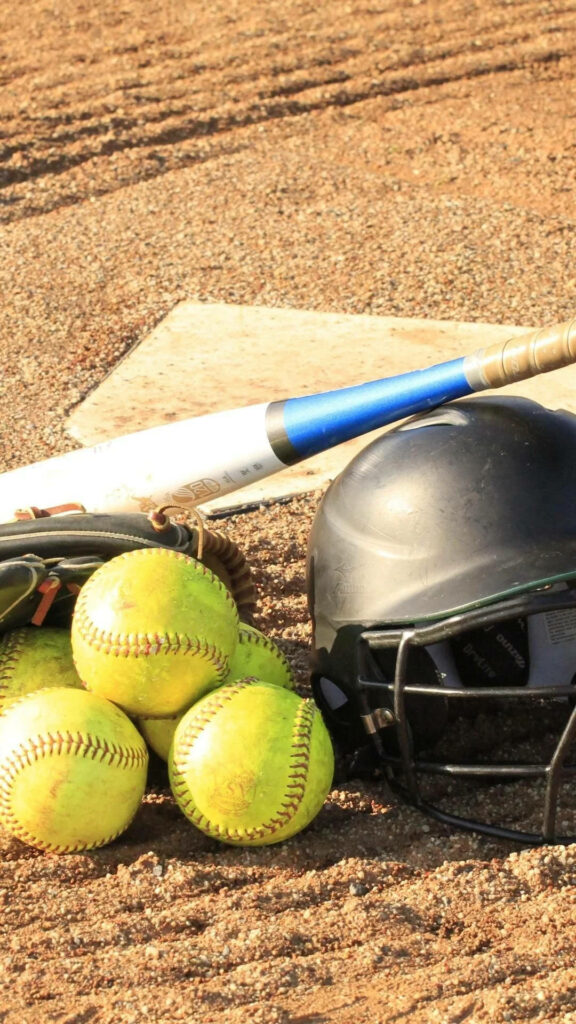 Playful Softball Field: Adorable Softballs and Bat Nestled in Sandy Surroundings Wallpaper