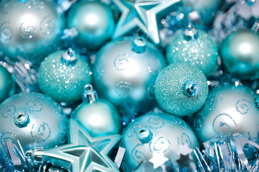 Festive Elegance: Gleaming Cyan Christmas Baubles on a Festive Background Wallpaper