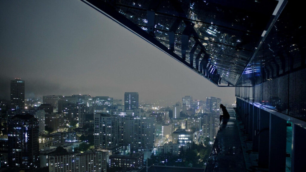Observing the Futuristic Cityscape: Cyberpunk 2077 Character Guazes at Metropolis from Rooftop Wallpaper