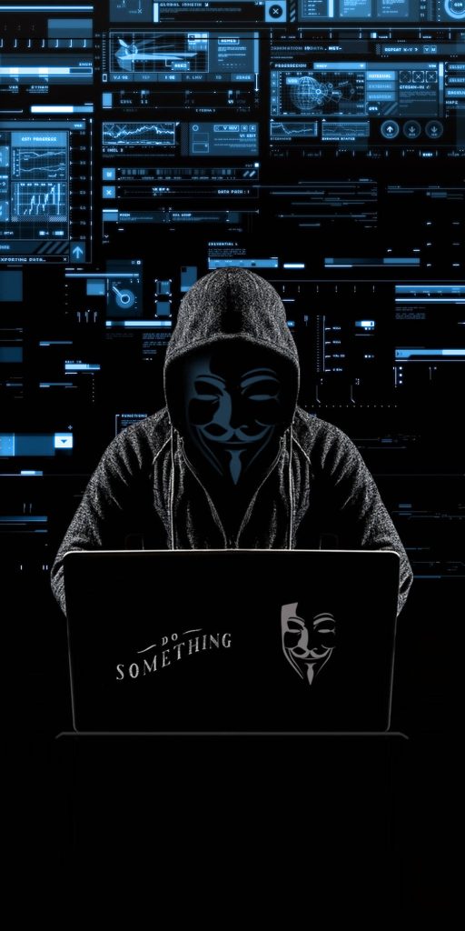 Cyberpunk hacker in hoodie with Guy Fawkes mask and glowing code laptop background wallpaper