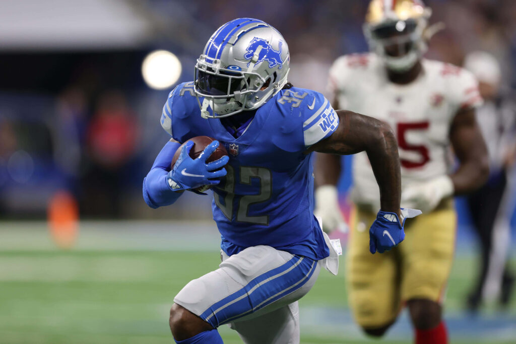 DAndre Swift Detroit Lions running with football in blue and silver uniform NFL action wallpaper