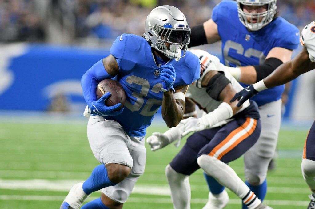DAndre Swift running back agility Detroit Lions vibrant football field dynamic sports action wallpaper