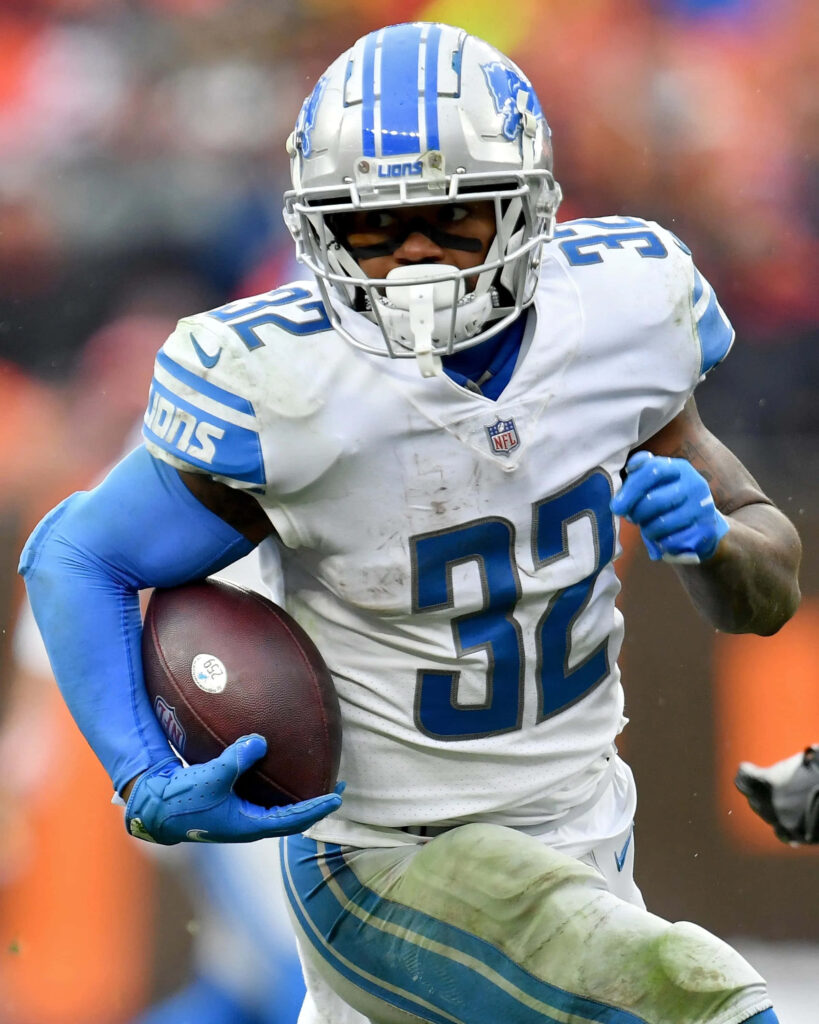DAndre Swift running back Detroit Lions sprinting with football in white blue uniform on field Wallpaper