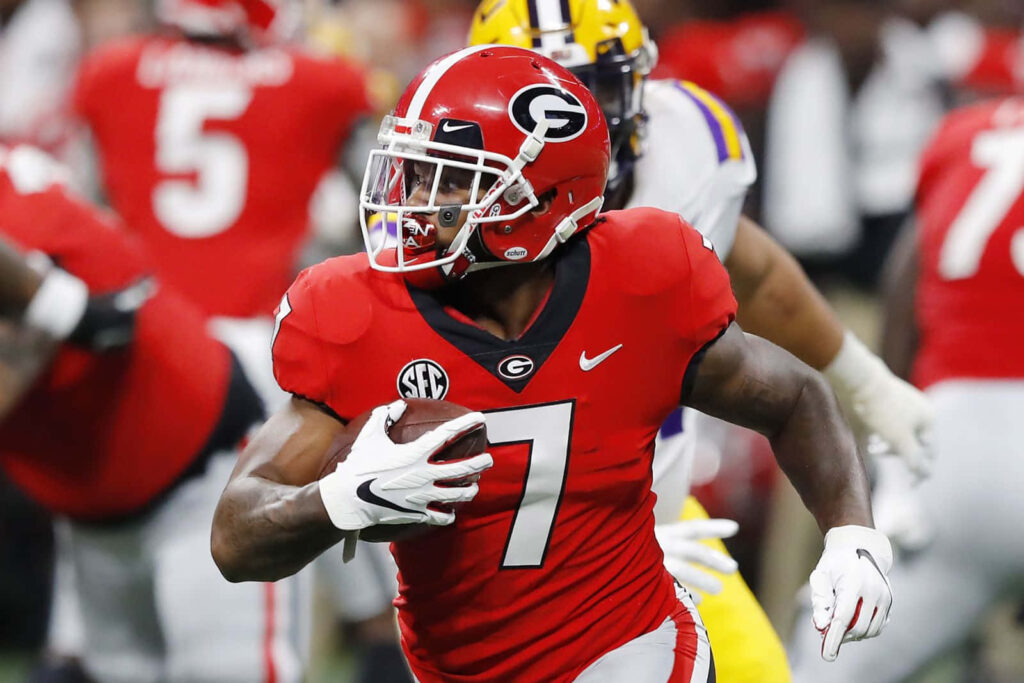 DAndre Swift running in red Georgia Bulldogs uniform number 7 dynamic football action wallpaper