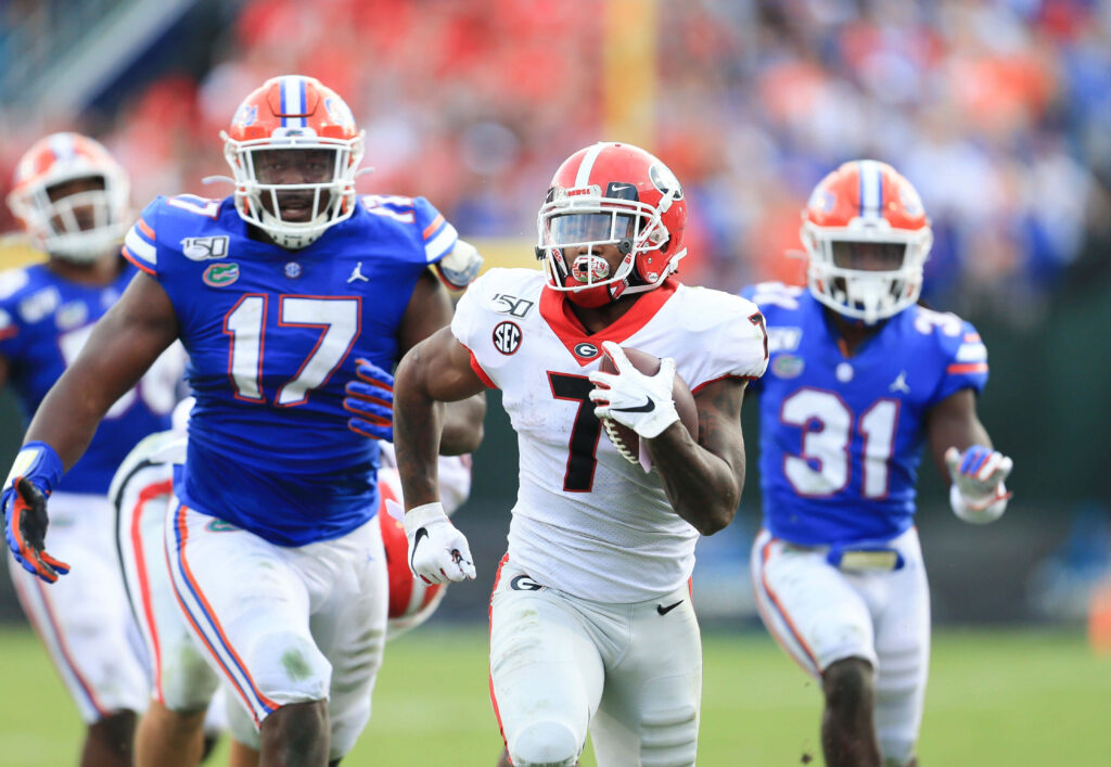 DAndre Swift breaks tackle in Georgia Bulldogs uniform vs Florida Gators vibrant college football action Wallpaper