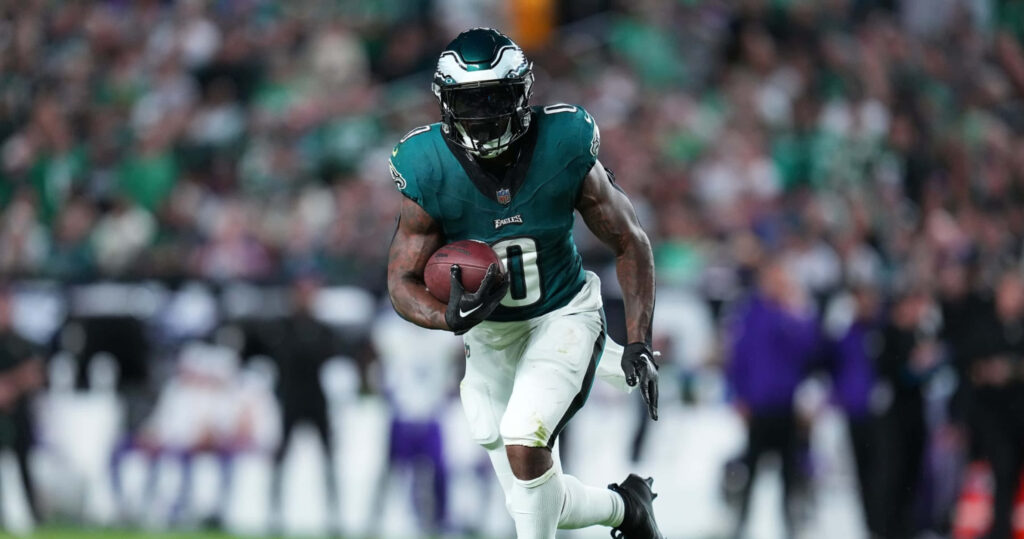DAndre Swift Philadelphia Eagles sprinting with football in green white uniform dynamic stadium background Wallpaper