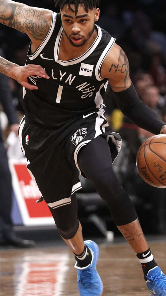 DAngelo Russell in Brooklyn Nets jersey showing athleticism and focus during live NBA game action Wallpaper