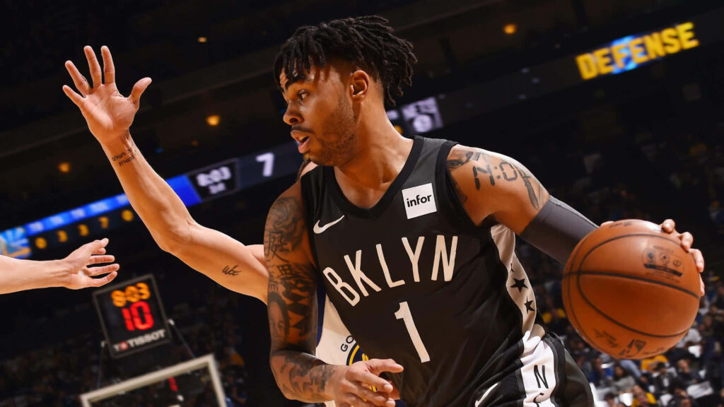 DAngelo Russell drives past defender in Brooklyn Nets jersey intense basketball action wallpaper