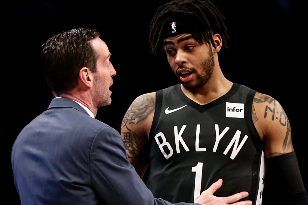DAngelo Russell and coach Kenny Atkinson in intense Brooklyn Nets courtside discussion NBA wallpaper