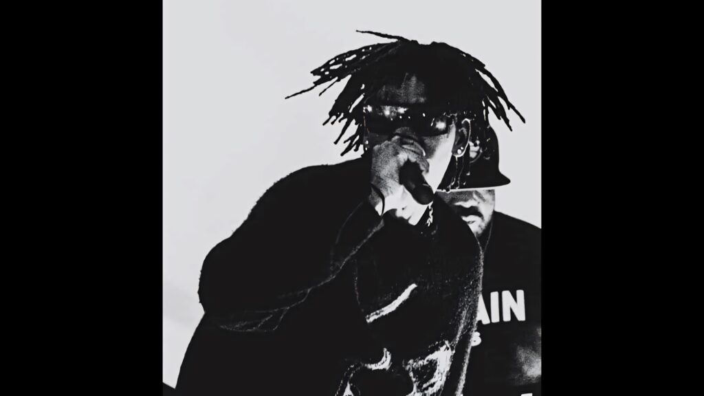 Black and white wallpaper of rapper DC The Don performing with dreadlocks sunglasses and microphone