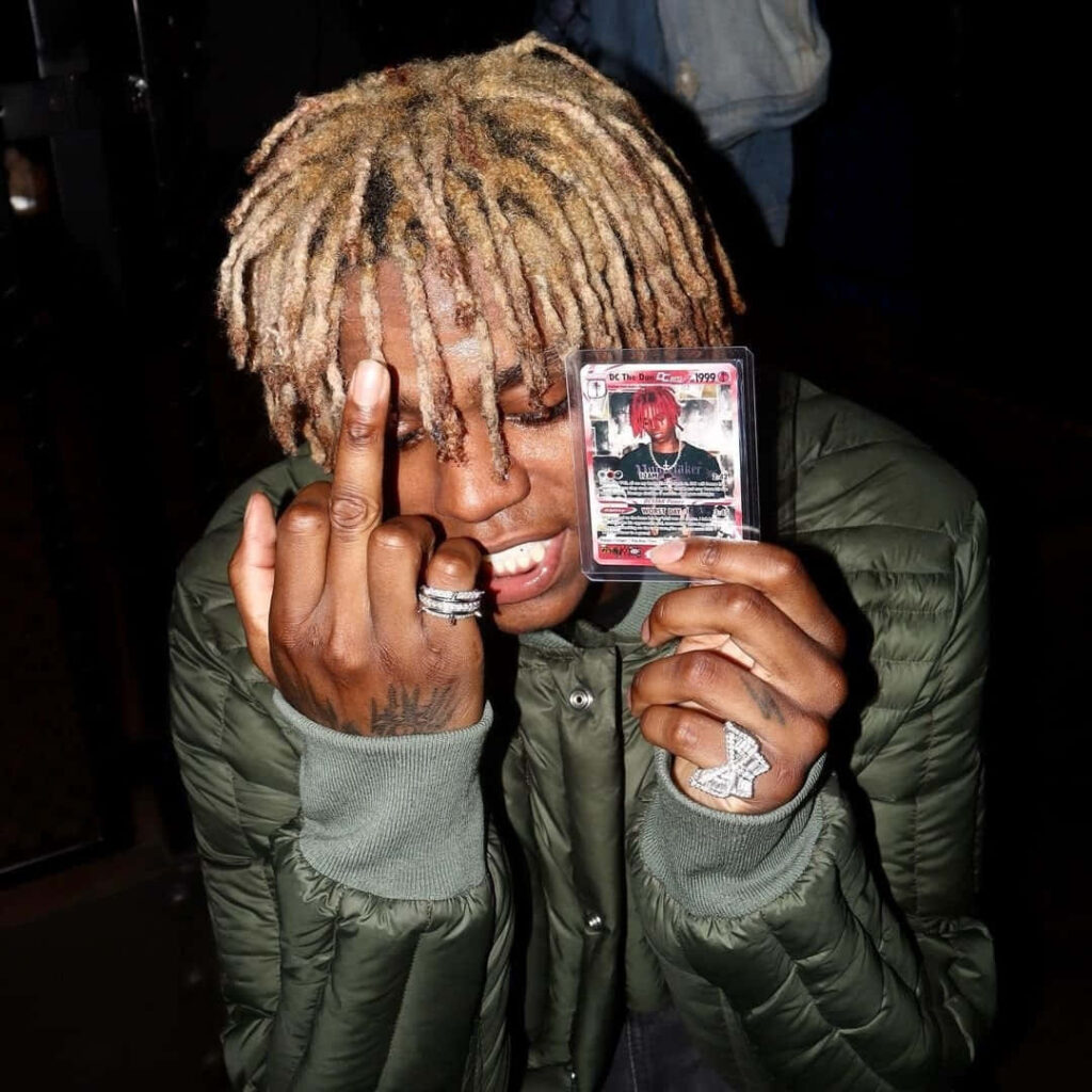 DC The Don with blonde dreadlocks dark green quilted jacket silver rings urban street style wallpaper