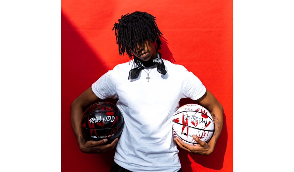 DC The Don in white tee and black bandana holding custom basketballs against red backdrop Wallpaper