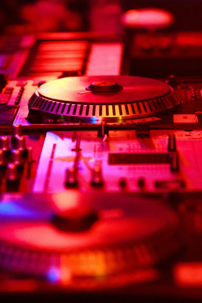 Vibrant DJ Console Wallpaper: Illuminated Red & Warm Nightlife Design