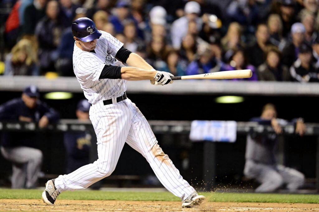 DJ LeMahieu hits baseball in pinstriped uniform under stadium lights at Yankee Stadium action shot Wallpaper