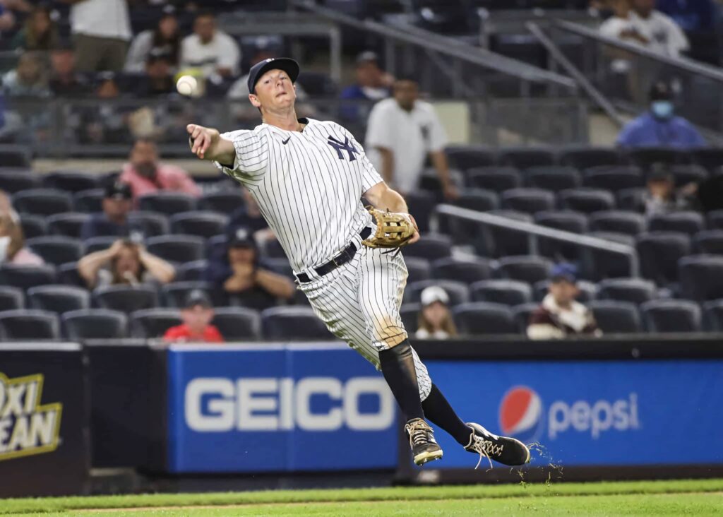 DJ LeMahieu in New York Yankees uniform hits baseball with vibrant Pepsi ads in lively stadium Wallpaper