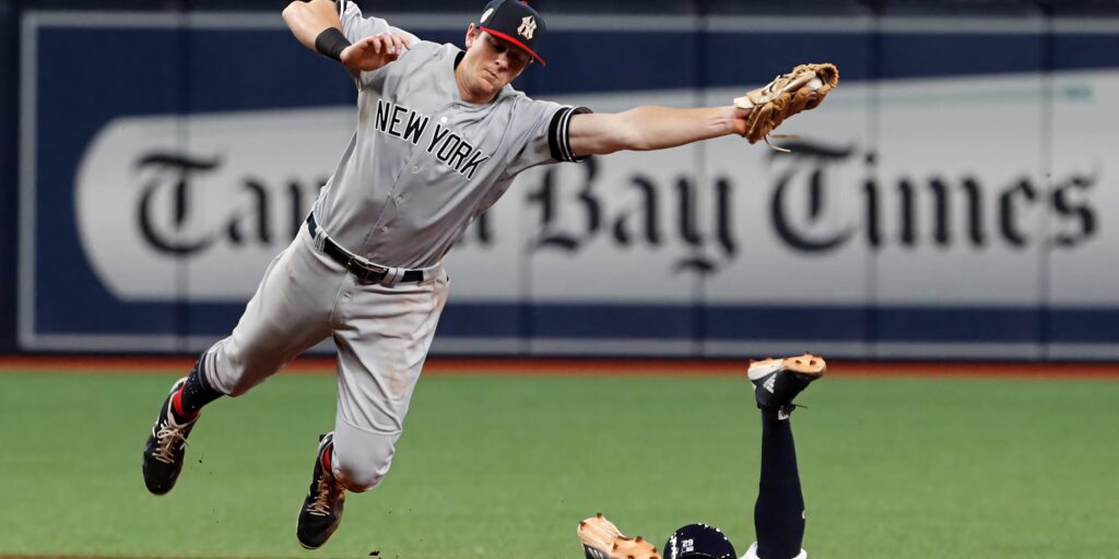 DJ LeMahieu mid-air catch New York Yankees dynamic baseball action wallpaper background