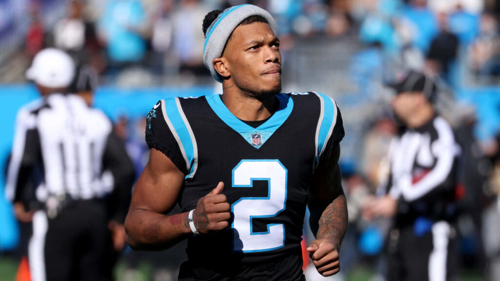 DJ Moore in black and blue Atlanta Falcons uniform number 2 playing football on vibrant field Wallpaper