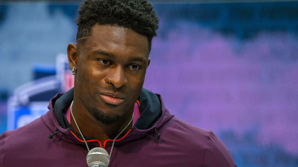 DK Metcalf intense gaze close-up wallpaper high resolution purple blue tones athletic build