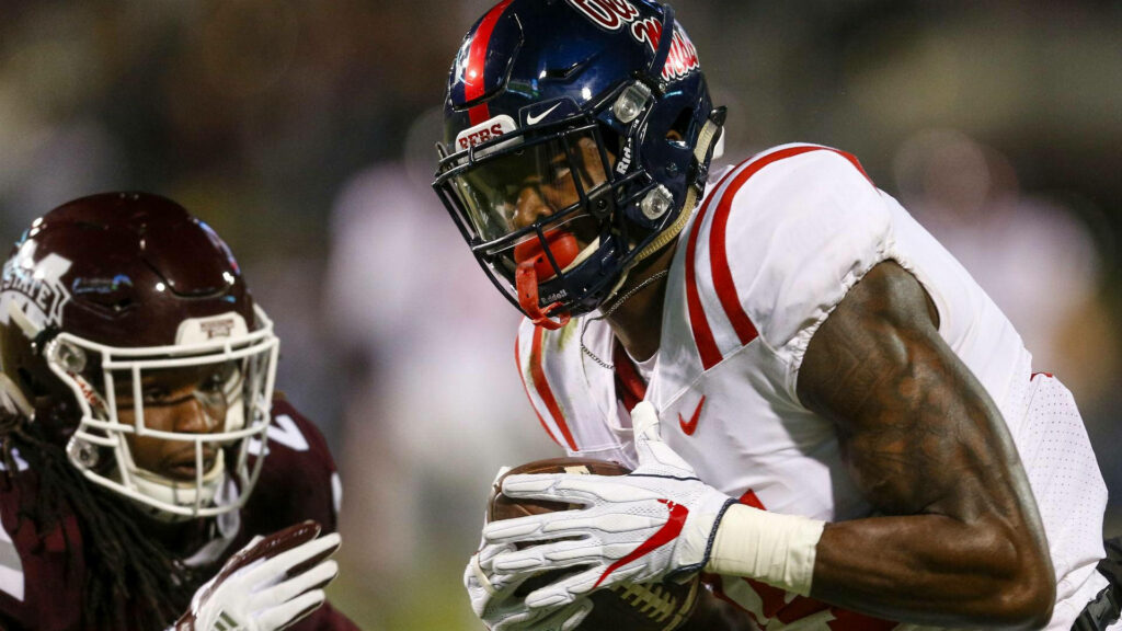 DK Metcalf in Ole Miss uniform intense action football wallpaper with vivid red white navy colors