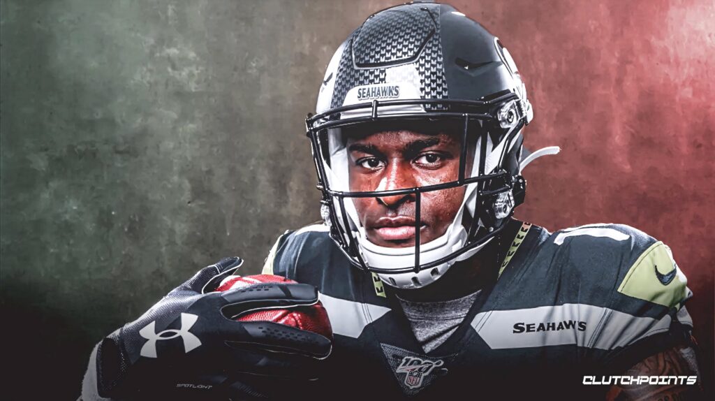 DK Metcalf Seattle Seahawks portrait gripping football intense focus dynamic football wallpaper