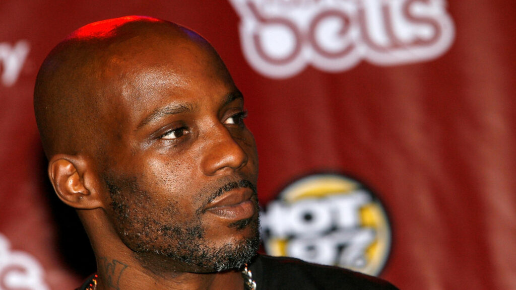 Close-up of DMX rapper with rugged beard and intense expression on deep red urban background wallpaper
