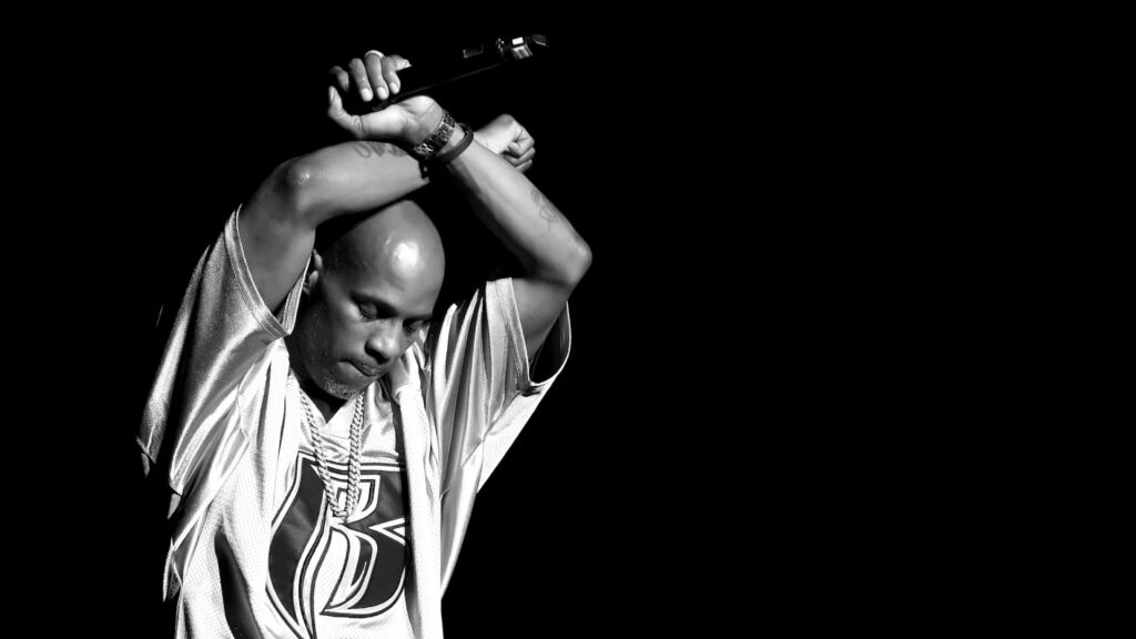 Grayscale DMX poster wallpaper rapper holding microphone bold black background intense pose