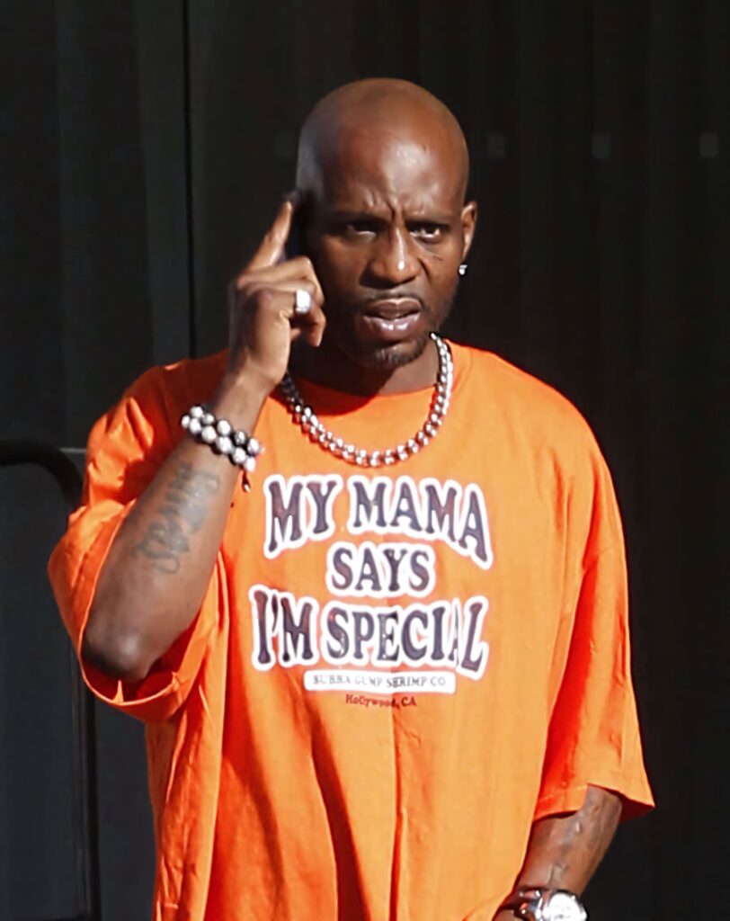 DMX rapper candid orange shirt intense expression iconic style muted background wallpaper