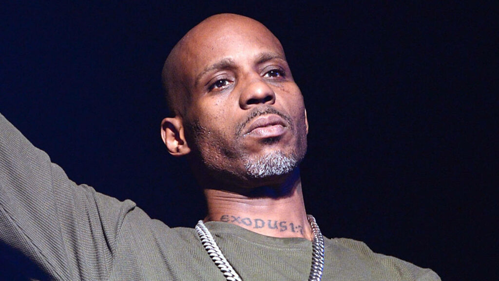 DMX rapper intense pose dark tones bold chain iconic bald look wallpaper background