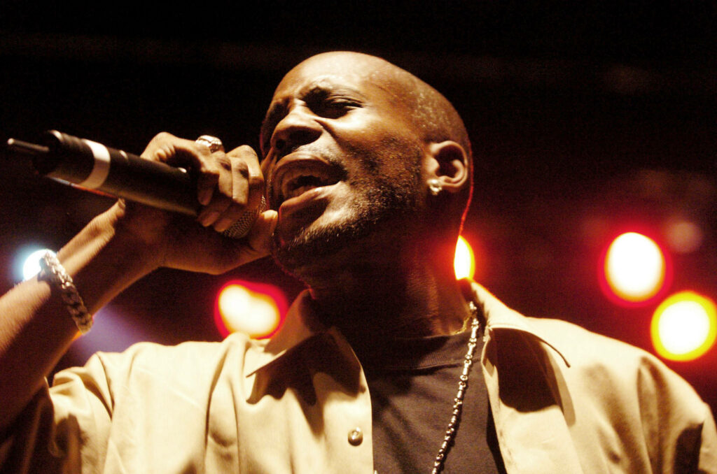 DMX performing live on stage with vibrant lights intense energy and iconic presence wallpaper