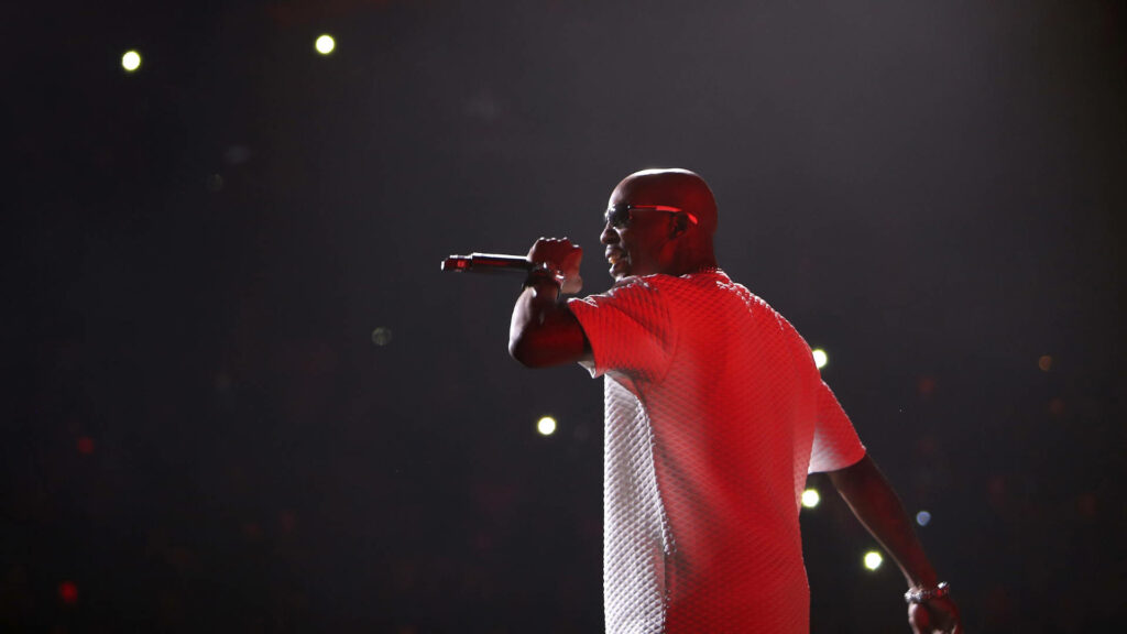 DMX performing live on stage with red lighting and glowing audience lights wallpaper background