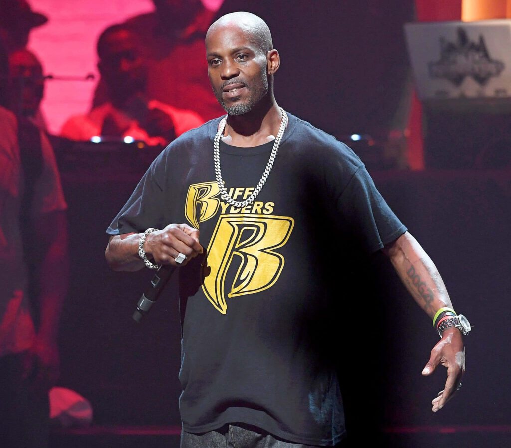 DMX performing live on stage wearing black Ruff Ryders shirt vibrant concert lighting wallpaper background