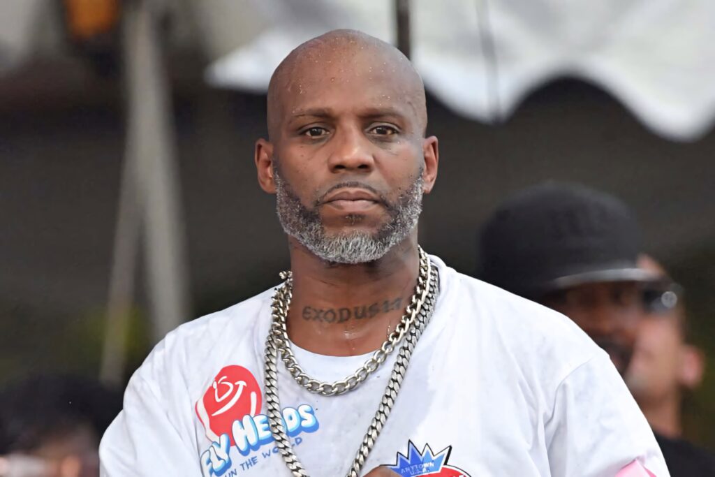 DMX rapper outdoors with tattoos chain necklace serious expression street style wallpaper background