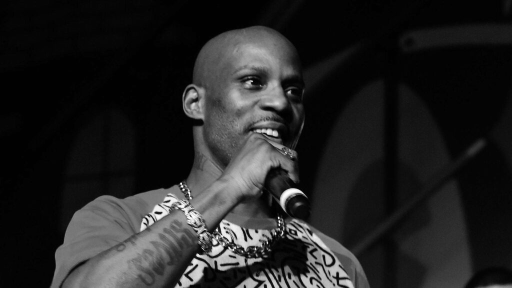 DMX rapper grayscale photo wallpaper performing on stage with intense expression and urban style