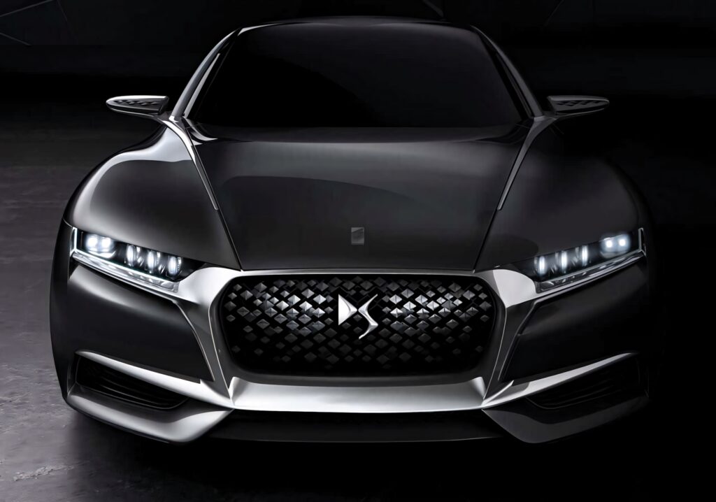 DS Automobiles sleek futuristic car with sharp LED headlights and diamond grille in black metallic Wallpaper