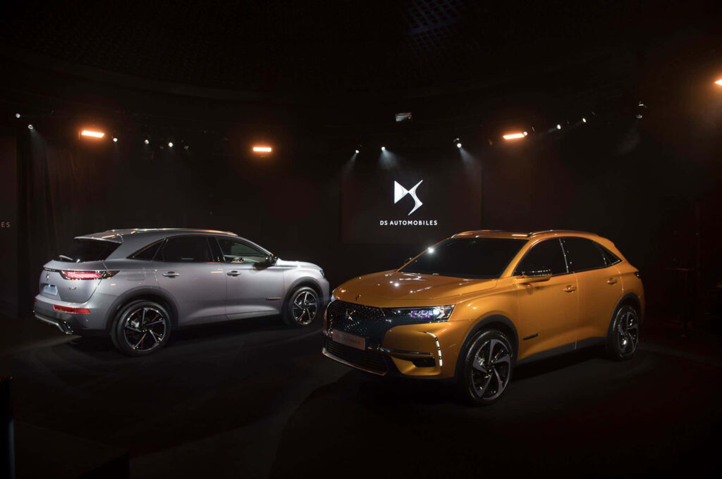 DS Automobiles wallpaper featuring two sleek silver and gold DS SUVs with dramatic lighting