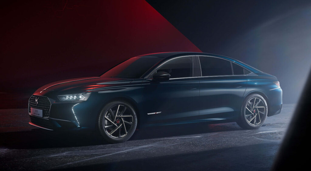 DS Automobiles sleek modern sedan with bold grille and alloy wheels in red and blue light Wallpaper