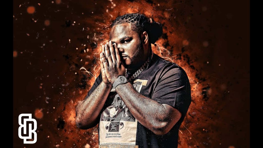Striking Da Real Gee Money tribute wallpaper with fiery background and glowing dramatic portrait
