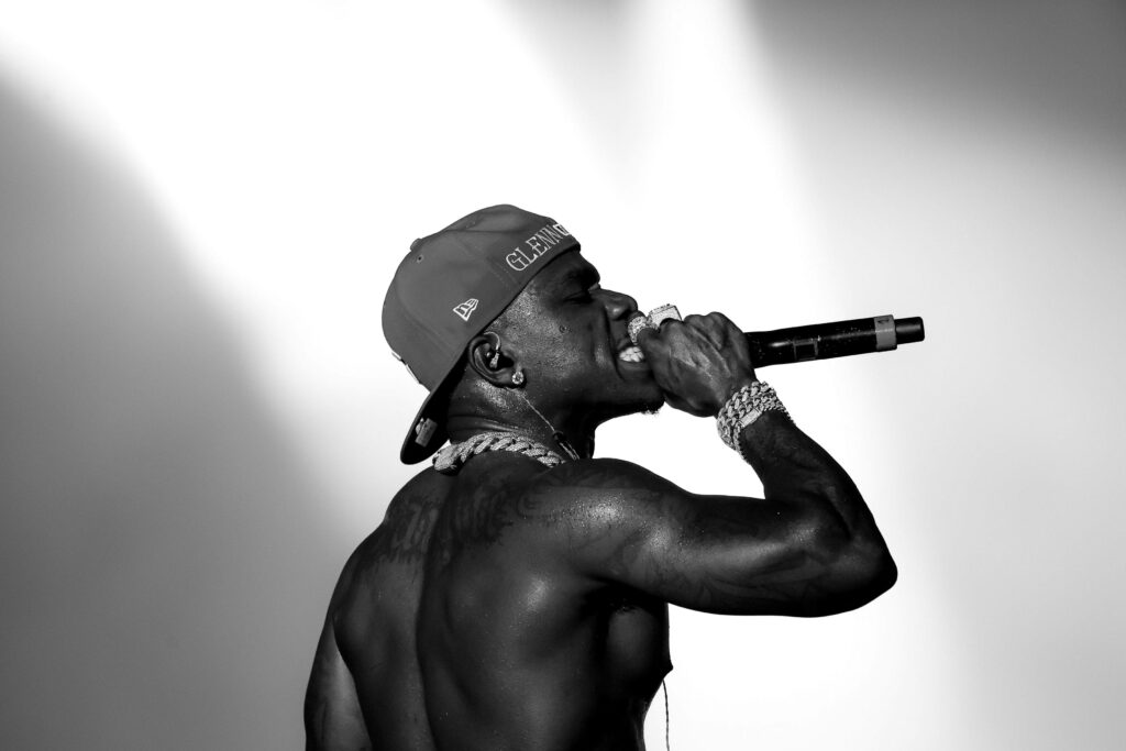 DaBaby performing at Rolling Loud monochrome wallpaper dramatic lighting dynamic stage presence
