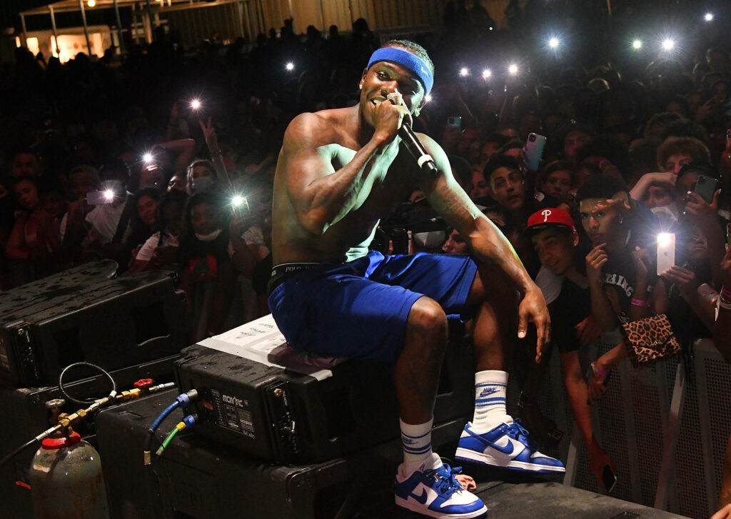 DaBaby shirtless performing live in blue shorts headband and sneakers at Orlando Amphitheater concert Wallpaper