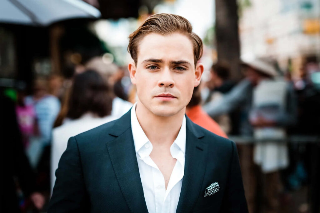 Dacre Montgomery in sharp dark suit white shirt confident pose urban background wallpaper