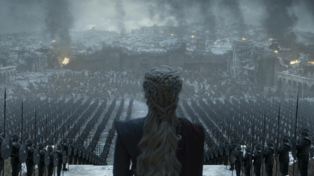 Daenerys Targaryen with braided silver hair leads army amid smoke over destroyed city wallpaper