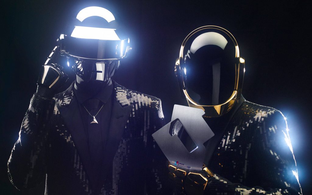 Daft Punk in sequined suits holding Official Charts Company number one award studio lighting Wallpaper