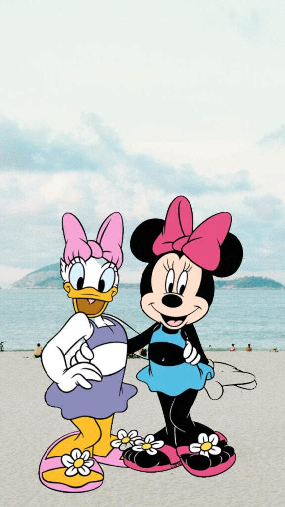 Daisy Duck and Minnie Mouse in colorful swimsuits on sandy beach with blue water and cloudy sky Wallpaper