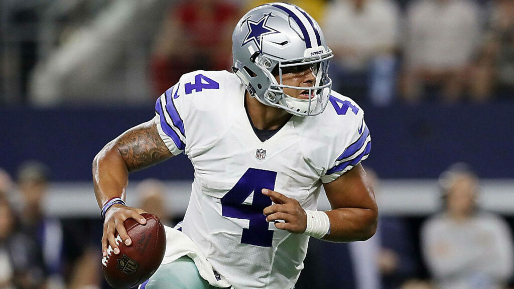 Dak Prescott Dallas Cowboys quarterback in action passing stance vibrant stadium background wallpaper