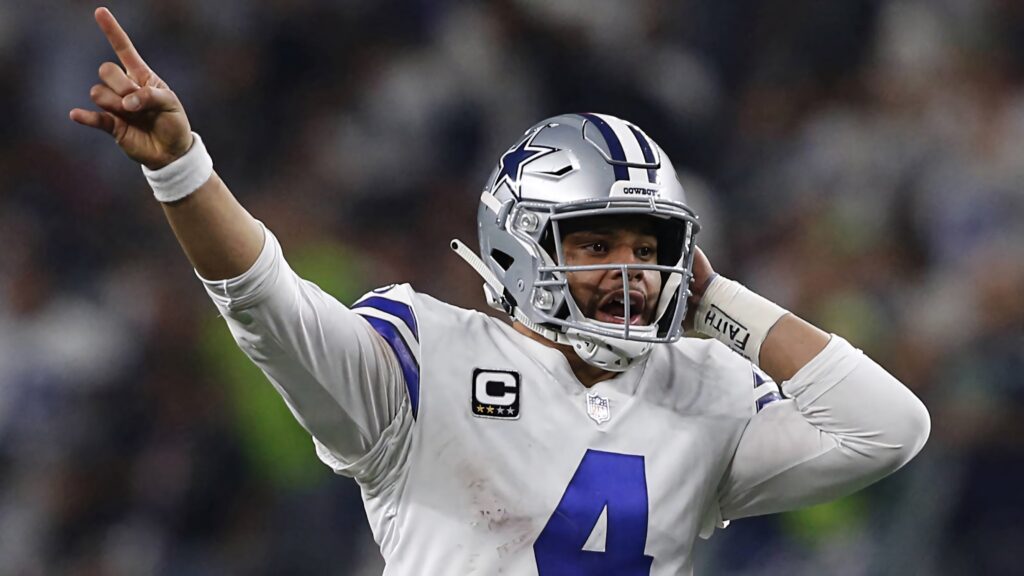 Dak Prescott in Dallas Cowboys silver helmet and white jersey number 4 intense game action wallpaper