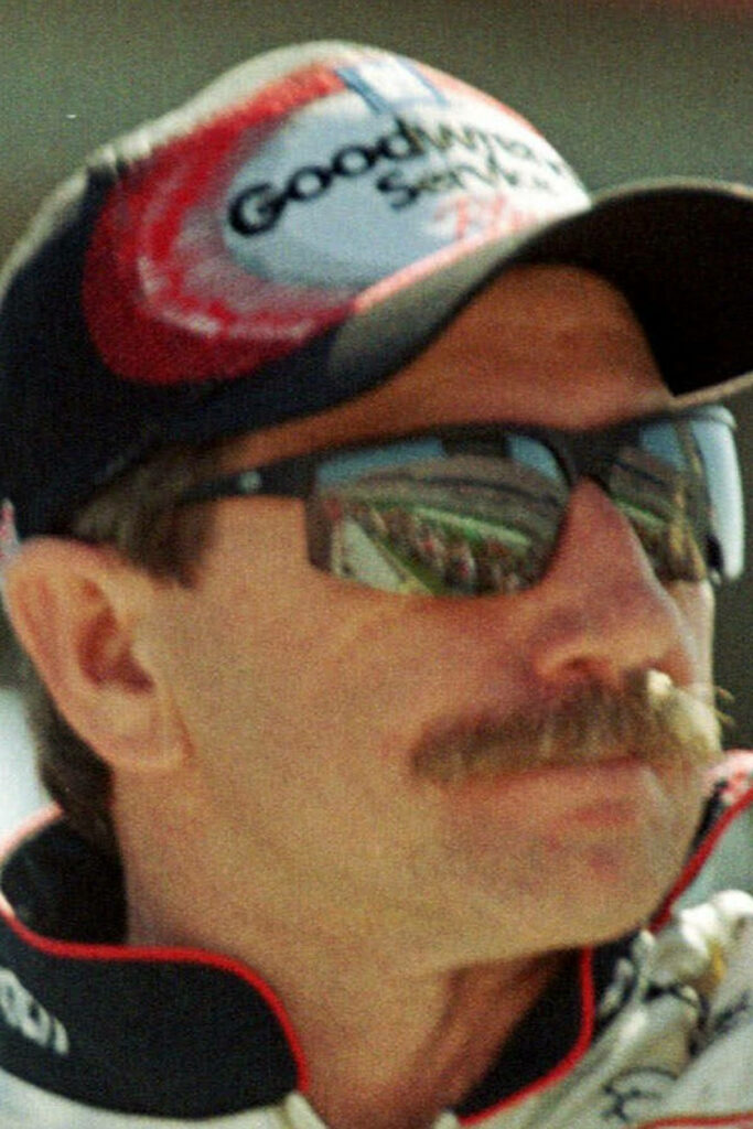 Close-up of Dale Earnhardt with mustache dark sunglasses and racing cap iconic NASCAR driver wallpaper