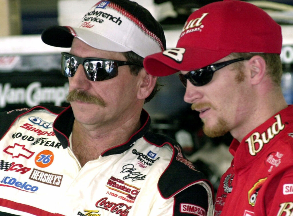 NASCAR legends Dale Earnhardt and Dale Earnhardt Jr in racing attire showcasing motorsport legacy Wallpaper